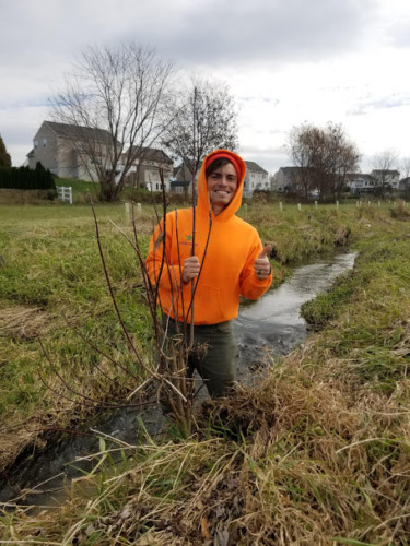 Chesapeake Forests Program Manager, Ryan Davis, poses with a gray dogwood shrub.