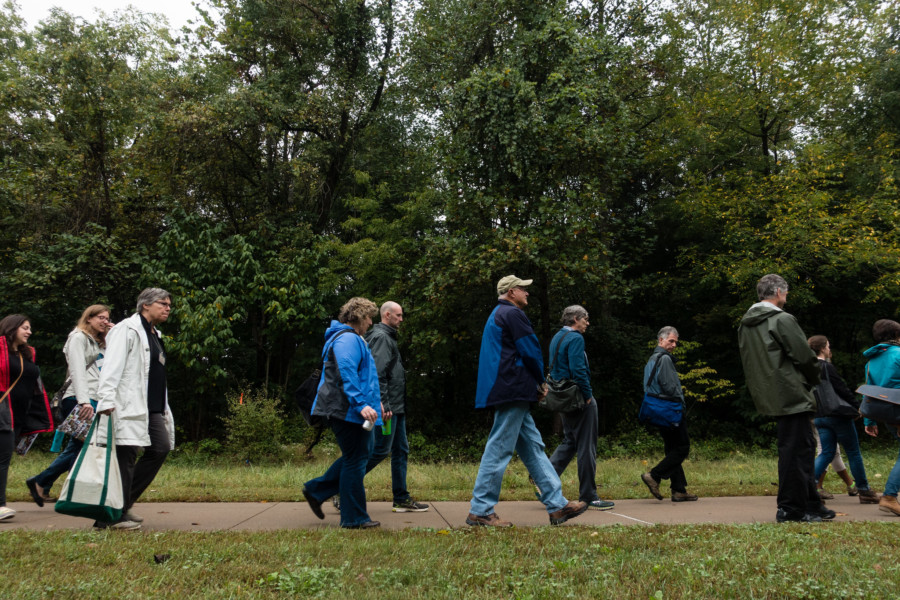 A group of people walk along the path between Instructional Halls East and West at the National Conservation Training Center in cold weather gear.