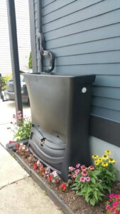 photo of rain barrel next to house