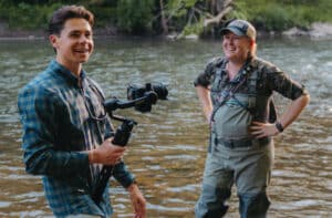 Two people smiling while standing in a creek