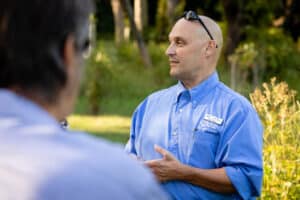 A person giving a presentation outdoors.