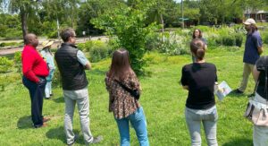 A person talking to a group of people outdoors.