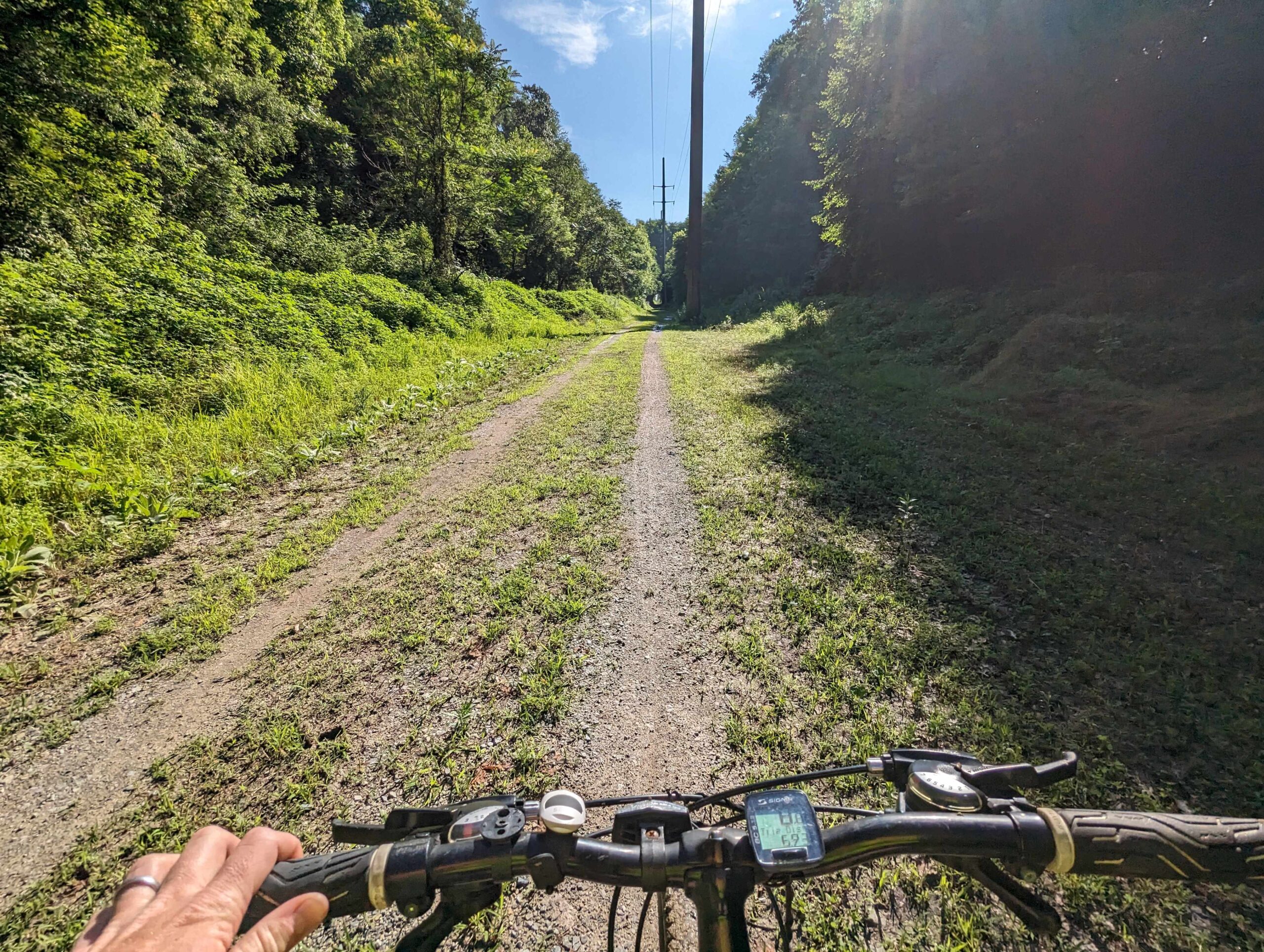 Bicyclist riding on a dirt trail.