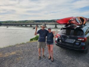 Two people standing in front of a dam