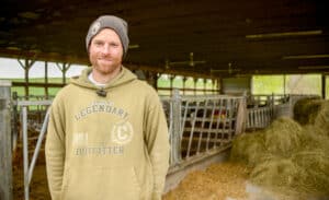 A person standing in front of a barn