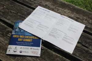 An event program displayed on a wooden bench