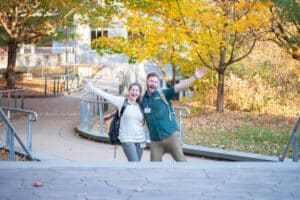 Two people smiling and holding their hands up in an excited fashion