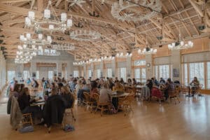 A large dining hall full of people talking and eating