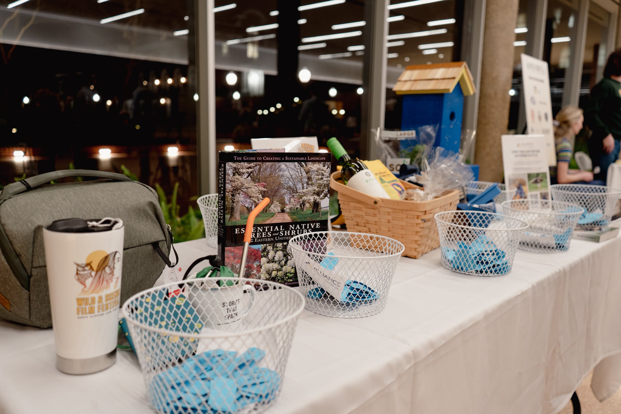 A table with raffle tickets and raffle items sitting on it