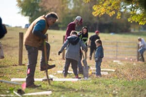 A group of people digging hole to plant trees in