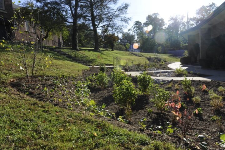 a garden area next to a church on a sunny day