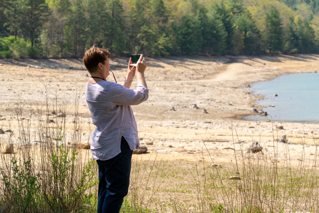 a person take a photo of a waterway on a sunny day
