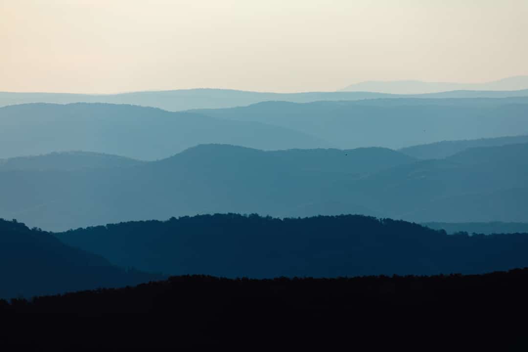 a foggy landscape of rolling hills