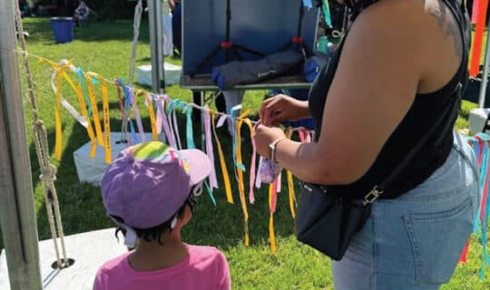 people hang ribbons on a taut string