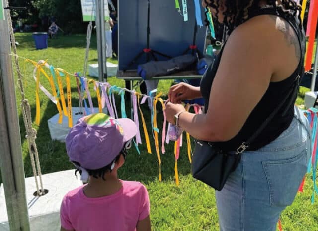 people hang ribbons on a taut string