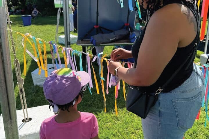 people hang ribbons on a taut string