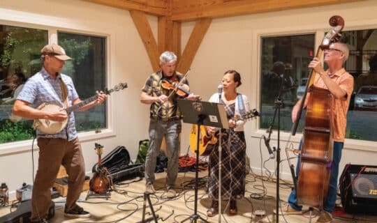 a band plays music on a small stage