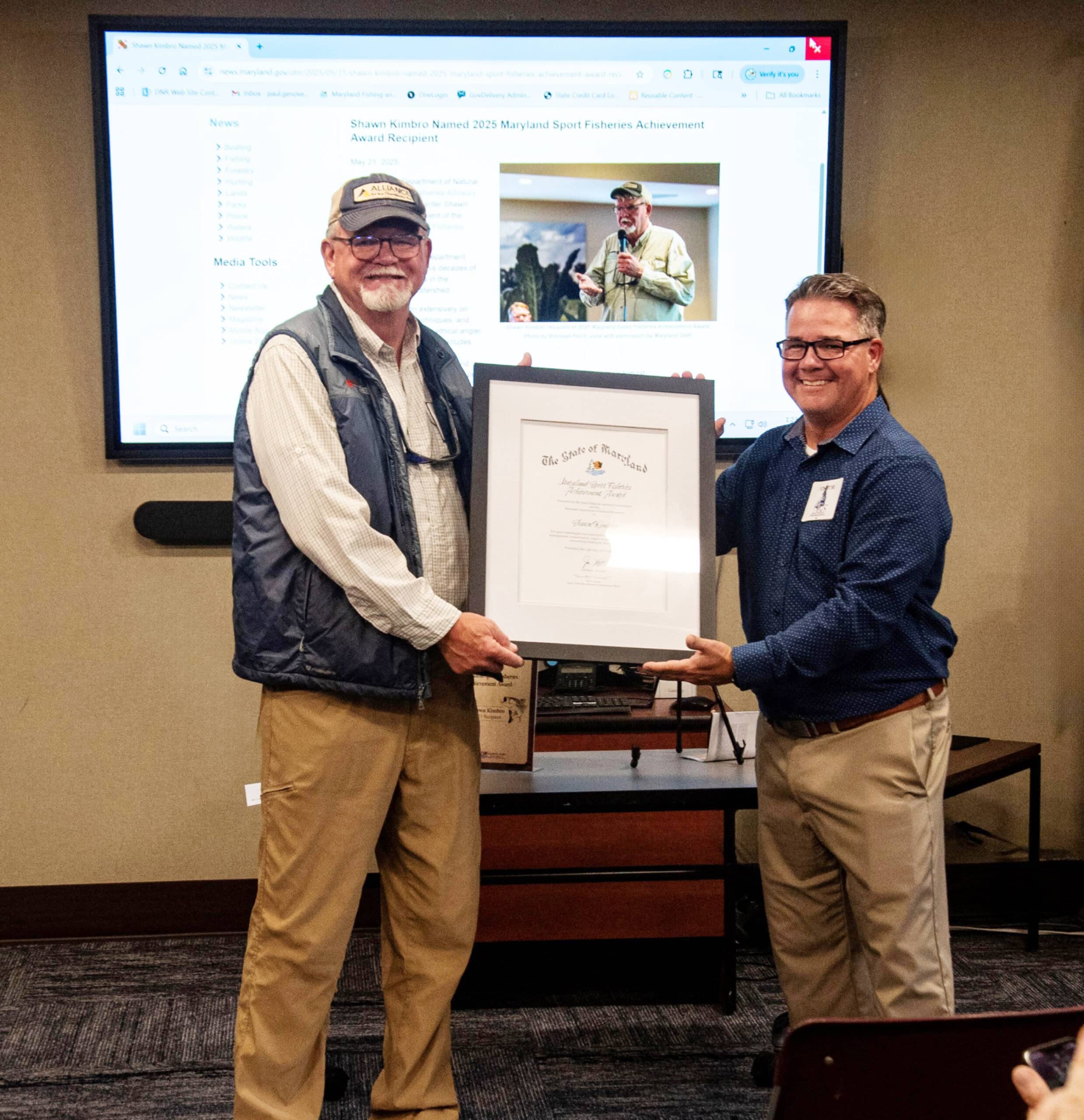 Shawn Kimbro (left) is presented with the 2025 Maryland Sport Fisheries Achievement Award from Scott Lenox (right), Chair of the Sports Fisheries Advisory Committee (SFAC). Photo credit: MD Department of Natural Resources 