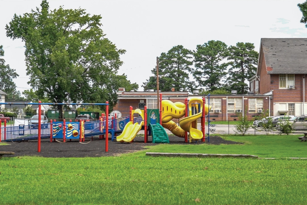 a colorful playground surrounded by a fence