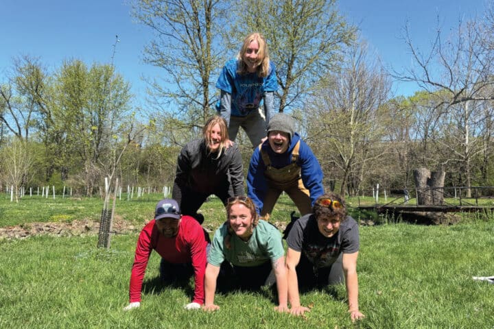 people forming a human pyramid and smiling