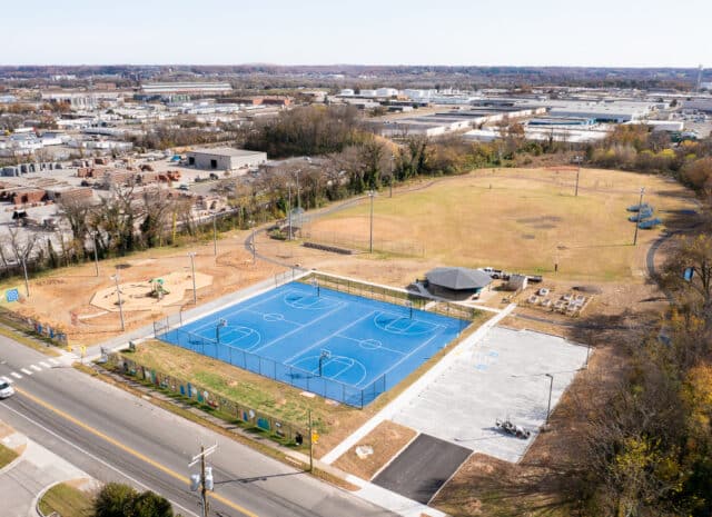 an aerial view of a park with blue basketball courts