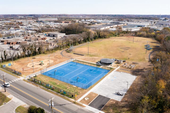 an aerial view of a park with blue basketball courts