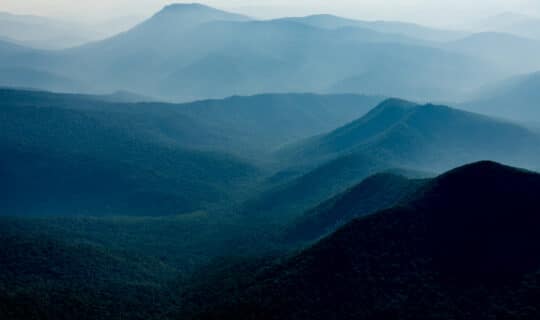 a landscape of forested mountains