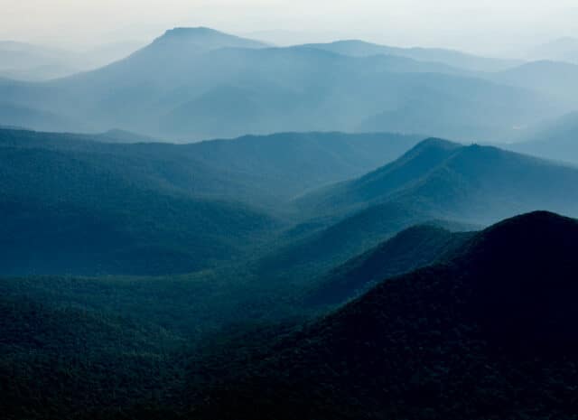 a landscape of forested mountains