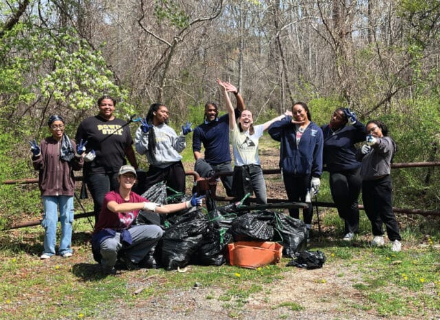 people posing for a group picture in nature