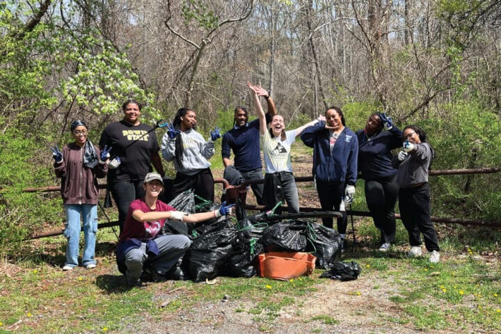 people posing for a group picture in nature