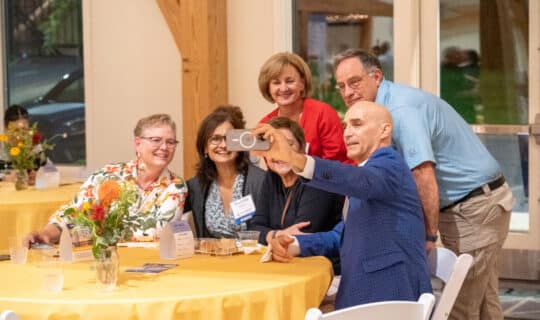 a group of people smile for a selfie