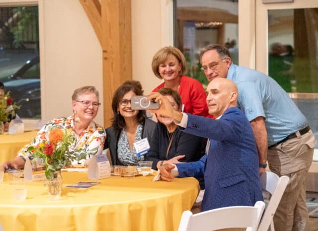 a group of people smile for a selfie